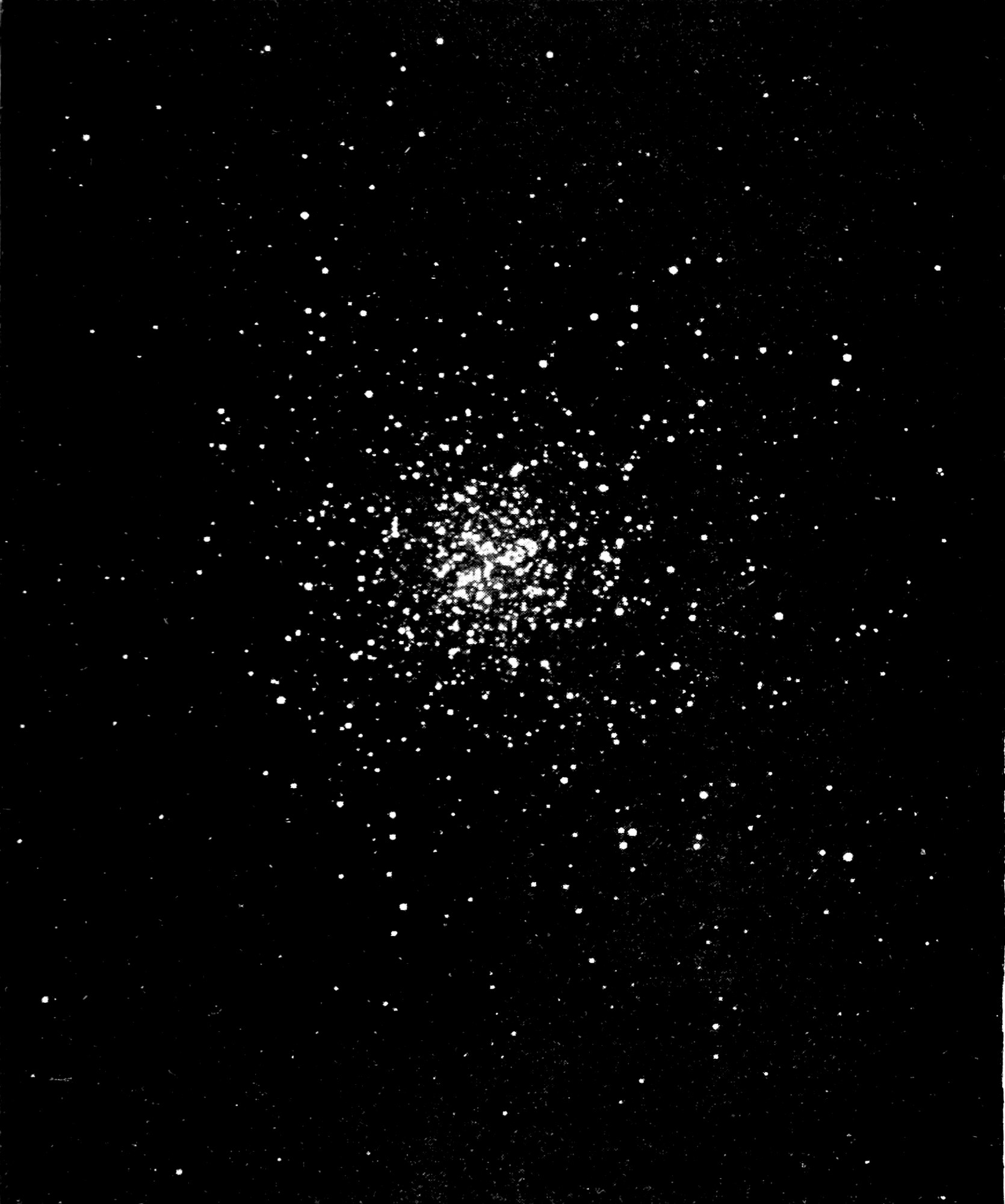 Fig. 61—The Great Cluster of Hercules, photographed at the Lick Observatory. — A photograph of a dense ball of countless small stars, packed thickest at the centre and thinning outward into the scattered stars of the surrounding sky.