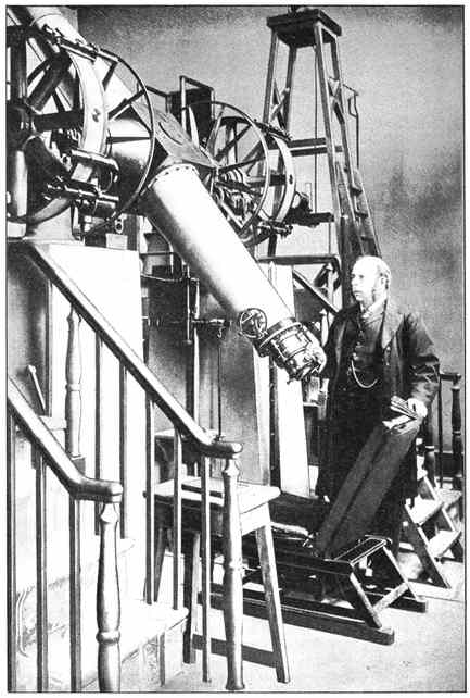 Sir Robert Ball beside the great refracting telescope at Dunsink Observatory, County Dublin, where he was Royal Astronomer of Ireland — the instrument standing on its iron mount with the observing steps and ladder drawn up beside it.