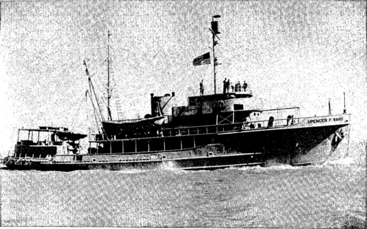 The SPENCER F. BAIRD (above), a modern oceanographic vessel. — A long two-deck ship under way on open water, seen from the side, with an American flag on its mast, several men on the upper deck and its name on the bow.