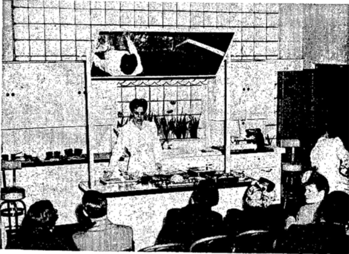 Photographs at right: (1) Fish cookery demonstration before a group of housewives. (2) Trailer laboratory equipped for field research. Such mobile laboratories handle principally emergency problems requiring quick action, or those that arise in areas remote from major laboratory facilities. (3) Conducting an experiment in fish canning. — In a tiled kitchen classroom, a woman in white stands behind a demonstration counter with a mirror tilted above it, while seated women in hats watch from the foreground.