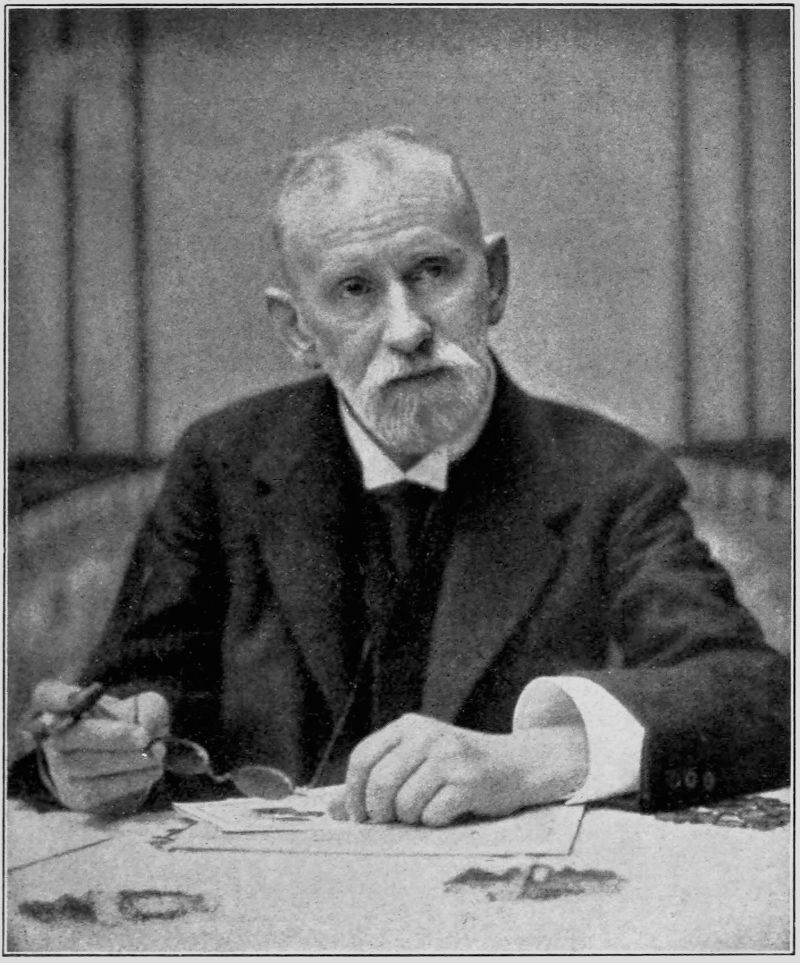 Last Portrait of Ehrlich — A photograph of him seated at a table strewn with papers, white-haired and white-bearded, a cigar and a pair of spectacles in one hand and the other resting on the papers.