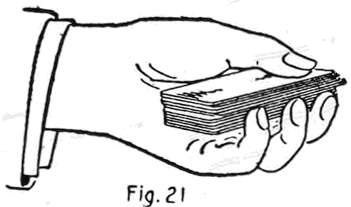 Fig. 21. — The left hand holding the deck with the fingers flat against the bottom, their tips rising at the side against the packet thrown on top, where the bottom cards are stopped to form the jog.