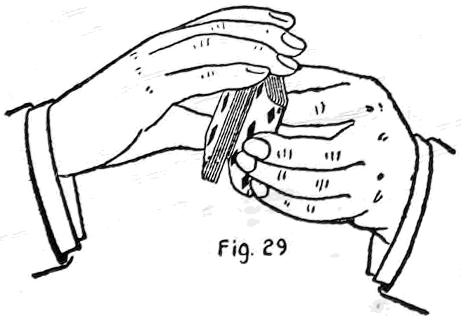 Fig. 29. — The lower side of the deck opened at a located card and fingers of the left hand inserted, slipping the card out to the top while the right hand covers the face.