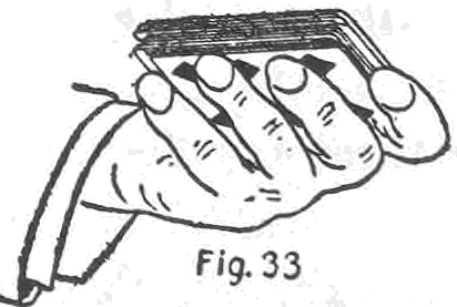 Fig. 33. — The left hand after the first shuffle of the two-card stock, with one card in-jogged over the little finger end of the packet and another out-jogged over the first finger.
