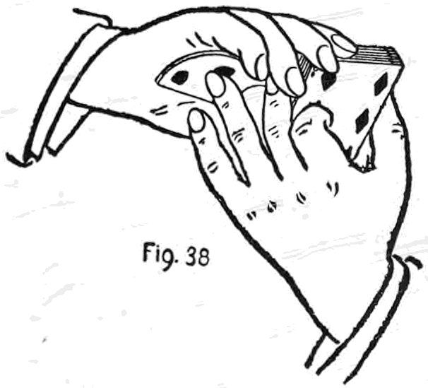Fig. 38. — Seen from beneath, the right hand holds the palmed cards against its palm while the deck is drawn half out from under it, and the left hand has let go.