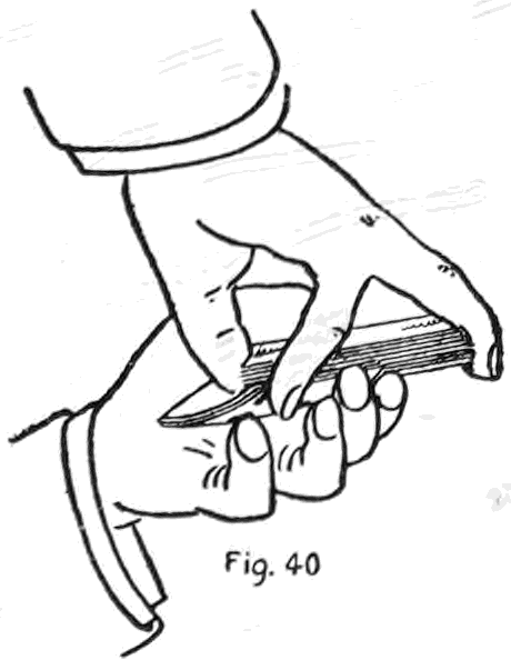 Fig. 40. — The right little fingertip catches the projecting corner of the under cards and draws them in toward the right thumb until they lie along the left palm.