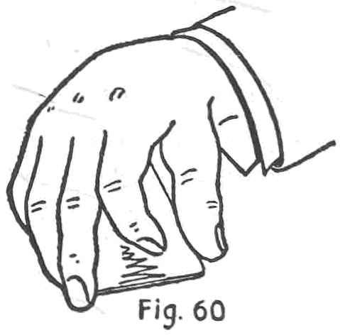 Fig. 60. — The right palm is turned downward over the cards, covering the sides and inner end so that neither the number held nor the overlap of the packets can be seen.