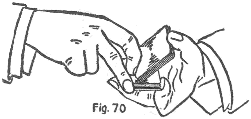 Fig. 70. — The right thumb and second finger draw the lower packet to the right and upwards while the right first finger presses the upper packet down against the left thumb.