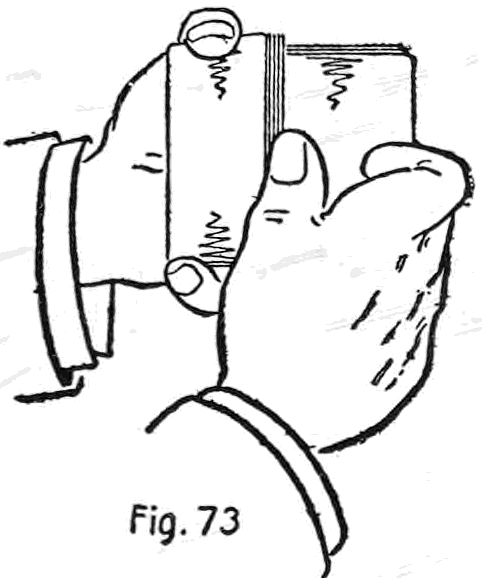 Fig. 73. — The packets reversing: the right hand holds the lower end of the deck, thumb along the side, while fingertips show at either end as the two packets tilt apart.