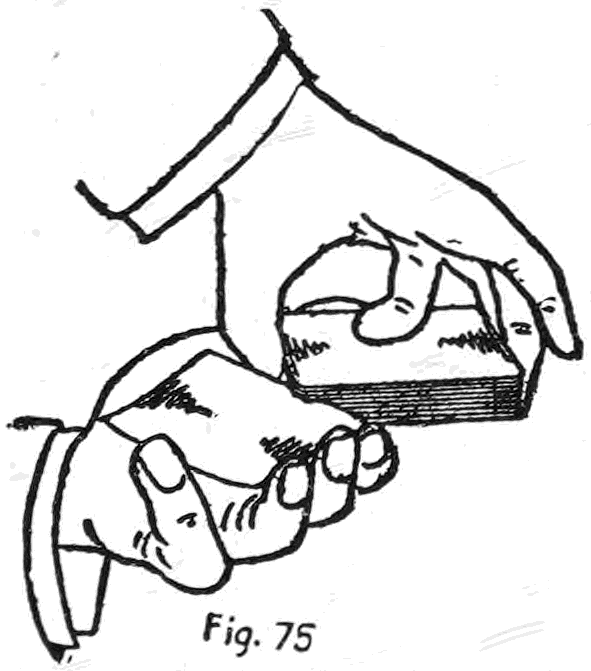 Fig. 75. — The palm-shift: the left hand turns over and inwards with the selected card palmed in it, while the right hand slides the deck out and away to the right.