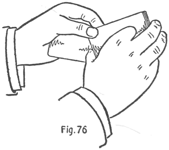 Fig. 76. — Alternatively the left hand, with the card palmed, takes the deck by its corner between the first finger and thumb, and the right hand is left free.