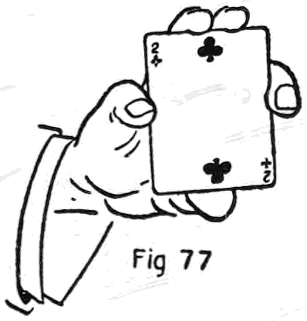 Fig. 77. — The Back Palm begins: the right hand holds a card face up, the two of clubs, between the thumb and the tips of the second and third fingers, first and little fingers at the sides.