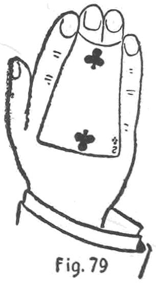 Fig. 79. — The fingers straightened, seen from the back: the two of clubs lies along the back of the right hand, its corners clipped between the first and second and between the third and little fingertips.