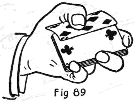 Fig. 89. — The First Method, one hand: the deck is held face up and the left thumb grips the top card, a diamond, drawing it back while the third finger tilts the deck up beneath it.