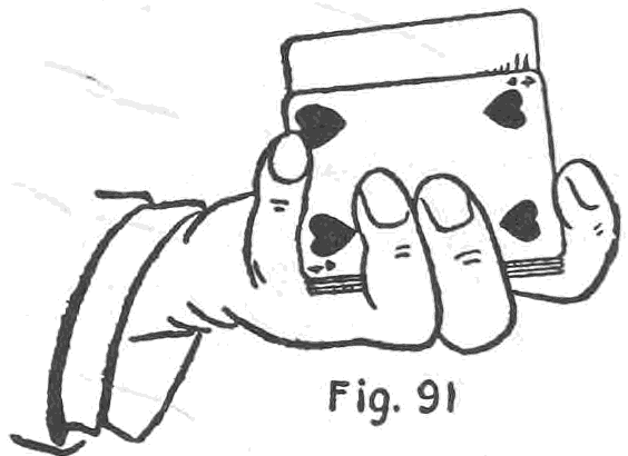 Fig. 91. — The Second Method: the left hand holds the deck on its side, and the thumb tip reaches over to push up the bottom card, the four of hearts, whose face shows toward the viewer.