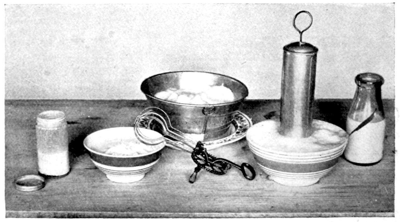 The Whipping of heavy and thin Cream. — A whip churn stands in a banded bowl of thin cream foamed up round it, beside a Dover egg-beater, a small bowl of whipped heavy cream, a pan of whip on a plate, and jars of cream.