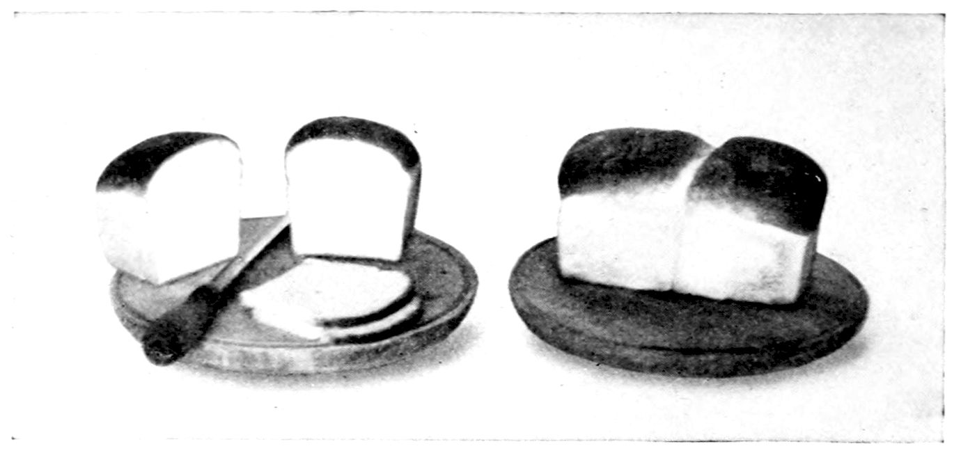 Double Loaves of Milk and Water Bread. — Two double loaves on round bread boards: one whole, its two rounded halves joined in the middle, and the other cut through, with slices laid beside it and the bread knife.