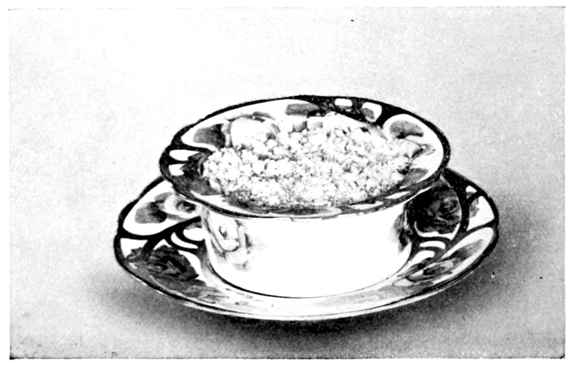 Sweetbread Ramequins. — A single ramequin dish with a flared, painted rim sits on a matching saucer, its contents covered with browned buttered crumbs.