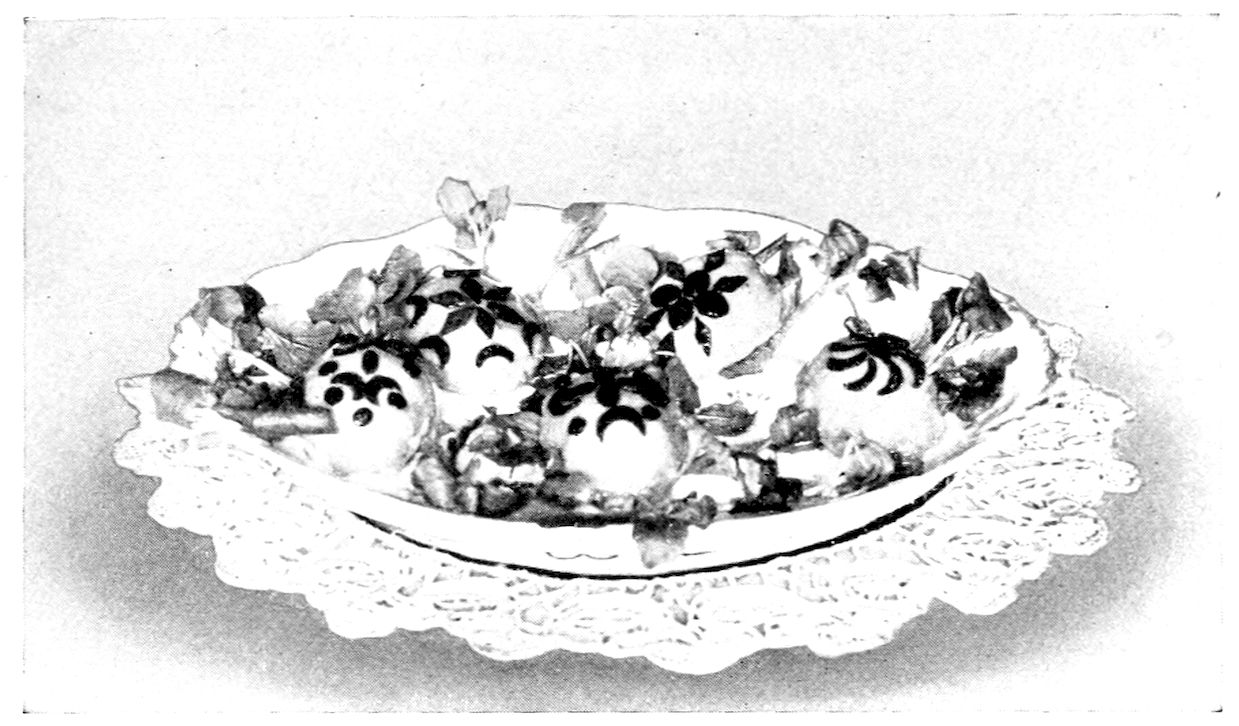 Chaud-froid of Eggs. — Egg halves masked in sauce and decorated with truffle cut into flowers, crescents and dots lie among sprigs of cress in an oval dish on a lace doily.