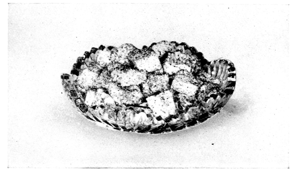 Toasted Marshmallows. — Squares cut from the marshmallow mixture, coated in crumbs of dried macaroons, piled in a shallow cut-glass dish with a scalloped rim.