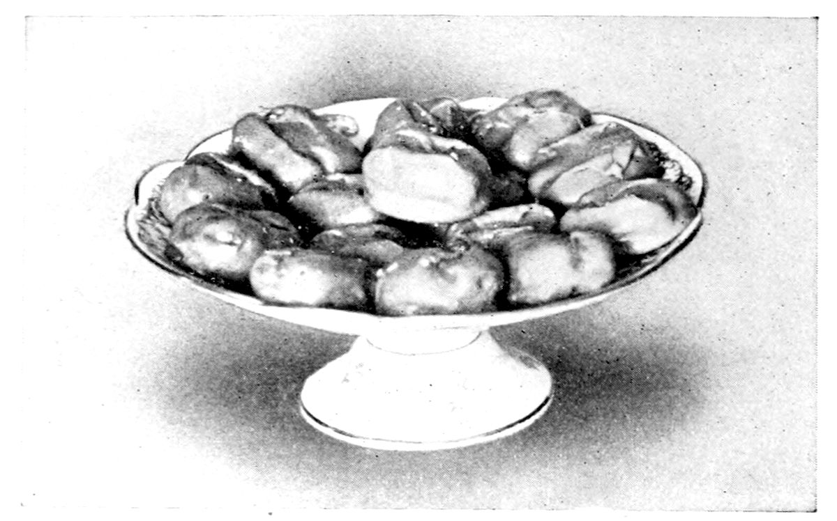 Dipped Walnuts. — A footed china dish holds a heap of walnut halves glossy with their coating of dipped fondant.