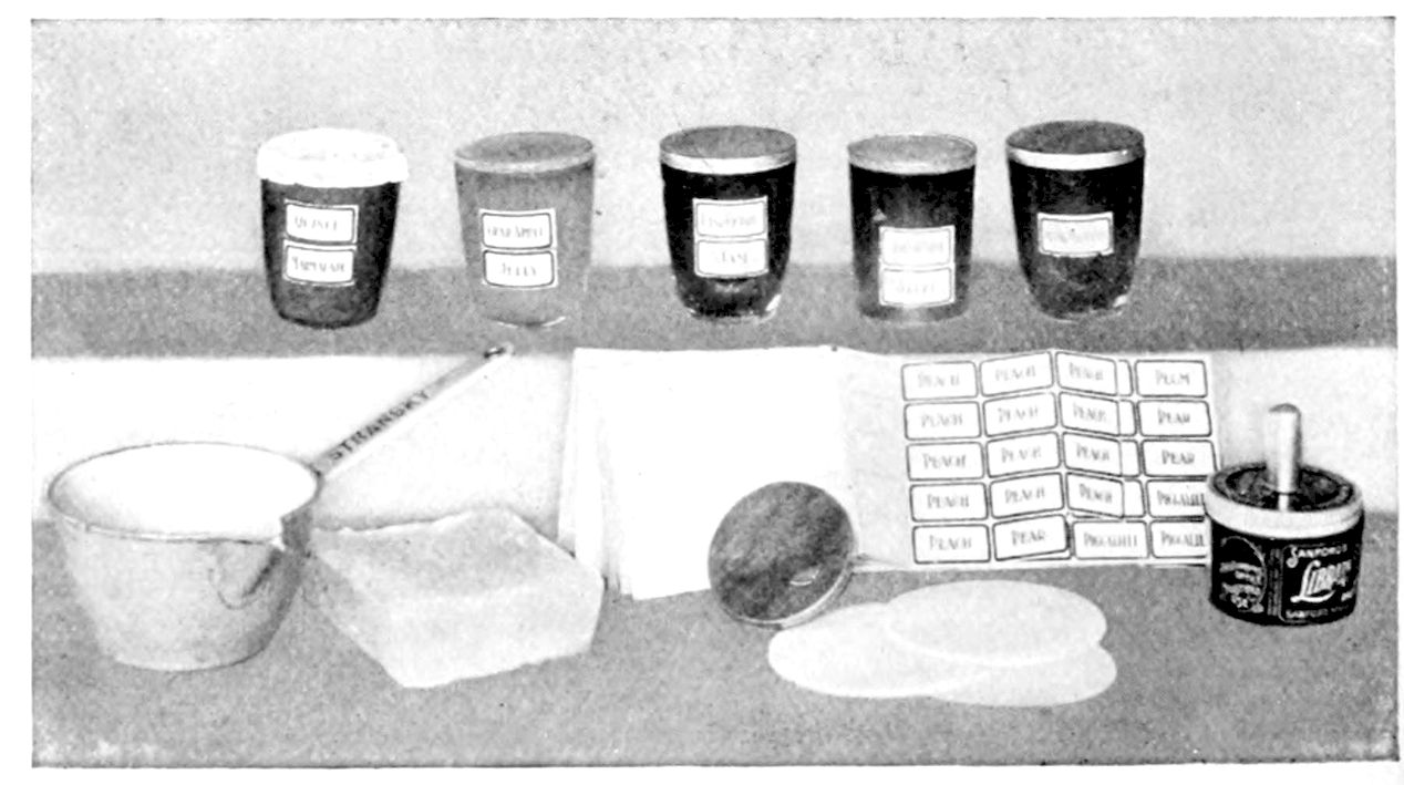Marmalades, Jam, and Jellies, with paraffine to melt for covering, paper cut for covers, gummed labels, and Library Paste. — Five glasses of marmalade, jelly and jam, labelled Quince Marmalade and Crab Apple Jelly among them, stand behind a saucepan, a cake of paraffine, round paper covers, a sheet of fruit labels and a pot of paste with its brush.