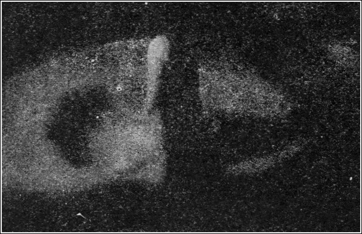 The splash 0.101 second after contact. The hole has filled in from all sides, and the inrushing liquid has overshot so far that it stands up as a tall pillar where the hole was; the first wave-crest is moving outwards around it.