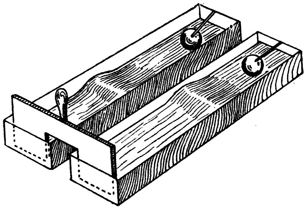 The double paddle, made of two pieces of wood joined together, which starts a wave in each of two tanks at the same instant — one filled to 6 inches and the other to 3, with a float at the far end of each.
