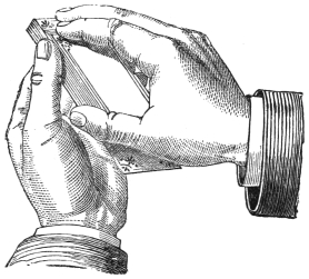 Fig. 28. — The right hand, palm above the cards, arches over the pack in the left hand, holding the drawn-down bottom card between its thumb and fourth finger while a fingertip draws down the cards from the top.