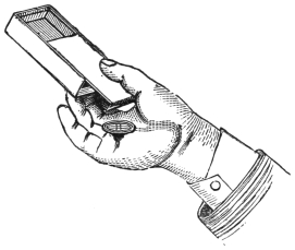 Fig. 83. — The rattle box held in the hand, sloping down towards the open end of its sliding lid, and the coin already fallen into the palm below.