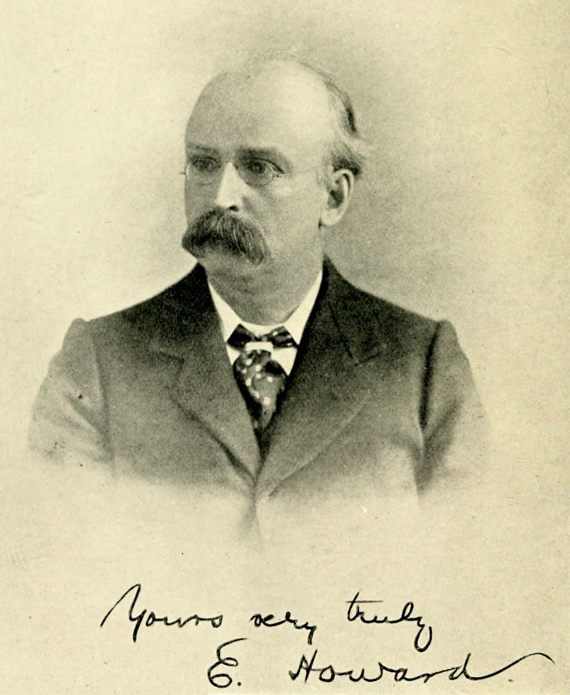 Ebenezer Howard — A head-and-shoulders photograph of Howard in spectacles, with a heavy moustache, dark jacket and patterned tie, looking off to one side; beneath it is his handwritten signature, “Yours very truly E. Howard.”