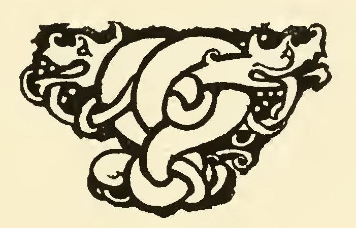 A small headpiece of two spotted, open-mouthed beasts twisted together in a Celtic knot.