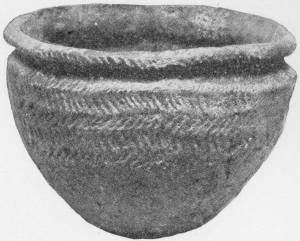 Specimen of Neolithic Pottery. Dug up at Mortlake from the Thames Bed. Brit. Mus. — A round-bellied clay bowl with a thick rolled rim, its sides impressed with rows of slanting herringbone marks.