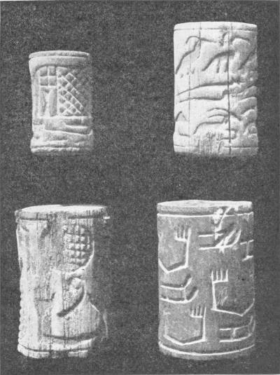 Ebony Cylinder Seals of First Egyptian Dynasty. Recovered from the Tombs at Abydos in 1921 by the British School of Archæology. They give evidence of early form of block printing — Four small cylinder seals photographed against a dark ground, carved with cross-hatching, birds, animals and stepped signs.
