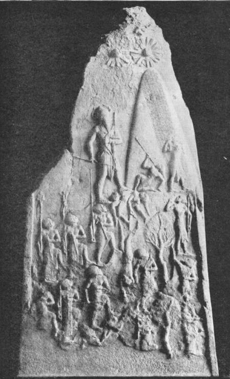 Stele Glorifying King Naram Sin, of Akkad. This monarch, son of Sargon I, was a great architect as well as a famous conqueror. Discovered in 1898 among the ruins of Susa, Persia — A tall pointed stone slab carved in relief: the king, larger than the rest, climbs a mountain slope over fallen enemies, with his soldiers below and star symbols at the peak.