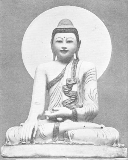 A Burmese Buddha. Marble Figure from Mandalay, eighteenth century work, now in the India Museum — A white marble Buddha seated cross-legged before a round halo, his right hand touching the ground and his robe edged with a dark patterned border.