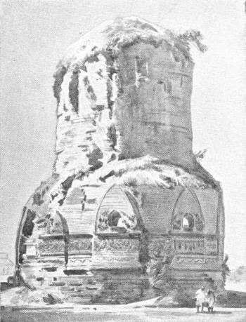 The Dhamêkh Tower. In the Deer Park at Sarnath. Sixth Century A.D. (From a Painting in the India Museum) — A painting of a massive round brick tower, its upper part crumbled and overgrown and its lower part ringed with carved panels and arched niches, with two small figures at its base.