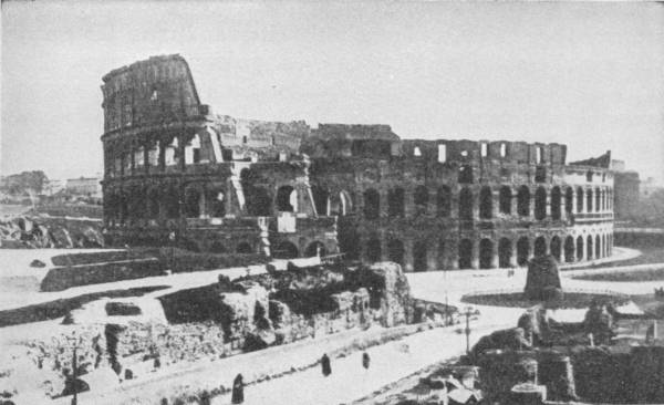 The Coliseum, Rome. Photo: Underwood & Underwood — The great oval of the amphitheatre seen from outside, with its full four storeys of arches standing on one side and the upper tiers broken away on the other.