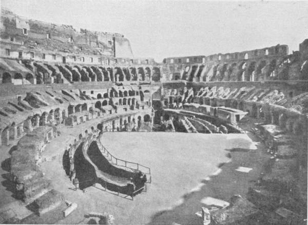 Interior of the Coliseum at It Appears To-Day — The inside of the amphitheatre, its seating stripped to bare banks of arches and walls, around an arena floor opened up to show the passages beneath.
