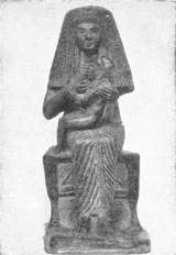 Isis and Horus — A small seated figure of a woman in a long headdress holding a child on her lap as she nurses him.