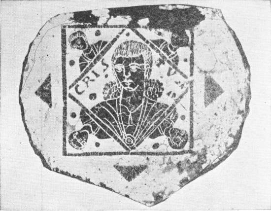 Early Ideal Portrait, in Gilded Glass, of Jesus Christ in Which the Traditional Beard Is Not Shown — A broken fragment of glass bearing, inside a diamond-shaped frame, the head and shoulders of a young, beardless man, with the letters CRISTUS at either side of his head and small figures at the corners.