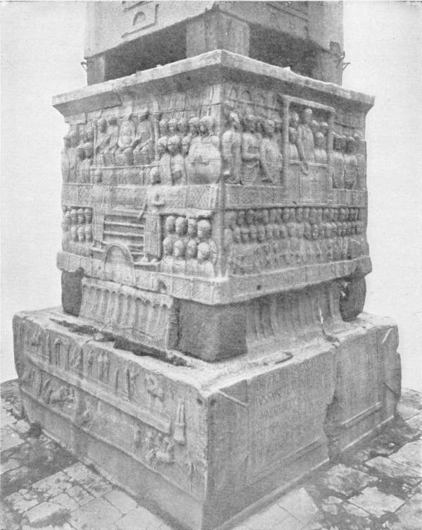 Base of the “Obelisk of Theodosius,” Constantinople. The obelisk of Thothmes, taken from Egypt to Constantinople by Theodosius and placed upon the pedestal here shown; an interesting example of early Byzantine art. The complete obelisk is seen in Chapter XLI. Photo: Sebah & Foaillier — The square stone pedestal on which the obelisk stands, carved on every face with rows of figures in relief, above a lower block bearing more carving and a Latin inscription.