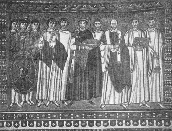 The Ravenna Panel, Depicting Justinian and His Court. Photo: Alinari — A mosaic of Justinian in the middle, crowned and haloed and holding a large bowl, with soldiers bearing a shield on his right and churchmen carrying a cross, a book and a censer on his left.