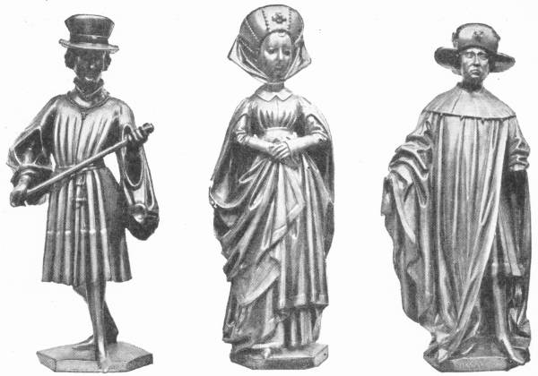 Costumes of the Burgundian Nobility: Flemish Work of the Fifteenth Century — Three small metal statuettes: a young man in a tall hat and short pleated tunic holding a staff, a woman in a wimple and long gown with hands folded, and a man in a broad hat and long cloak.