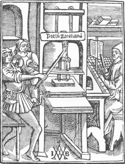 An Early Printing Press. (From an old print) — A woodcut of a print shop: one workman hauls on the long bar of a wooden screw press labelled “Prelu Ascensianu”, another stands behind with the inking balls, and a compositor sets type at a case on the right.