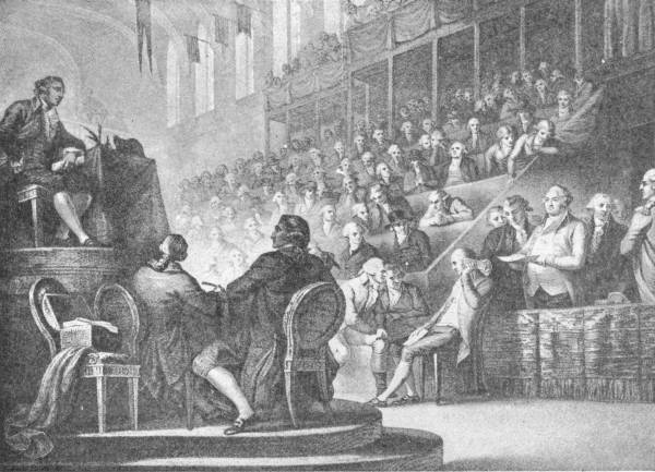 The Trial of Louis XVI. (From a print in the British Museum) — The king sits at the bar of a crowded hall, his counsel at a table before him, while deputies fill the tiered galleries above and a president speaks from a raised desk.