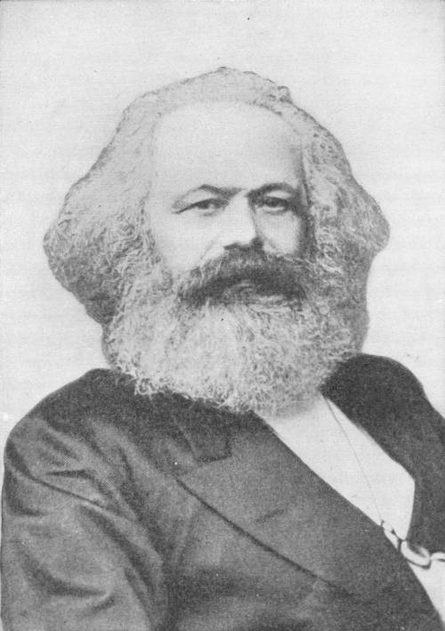 Carl Marx. Photo: Linde & Co. — A photograph of Marx in later life, head and shoulders, with a great mane of white hair and a full white beard, wearing a dark coat.