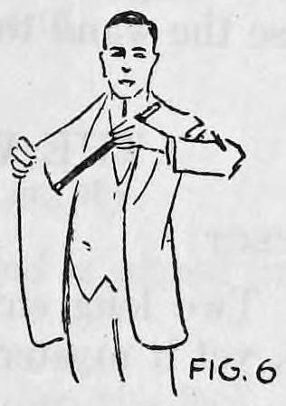 Fig. 6. — The performer in a suit coat reaches with his left hand across to his right coat pocket, drawing out the regular wand.