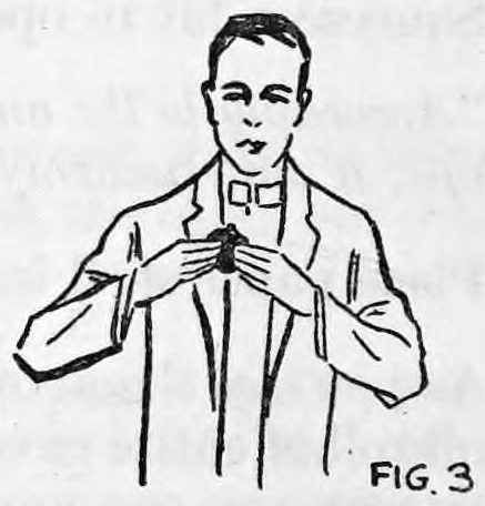 Fig. 3. — A smiling man in a suit holds the pocketbook in both hands in front of his chest, concealing the slit at the bottom with his fingers.