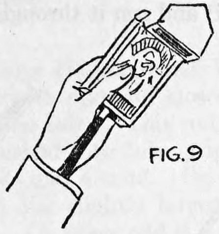 Fig. 9. — A hand holds the card case upright while the end of the wand is pushed up through the hole in the case's bottom.